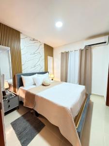 a bedroom with a large bed and a mirror at Comfort Home in La Cana