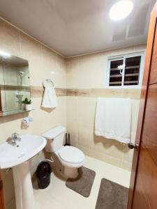 a bathroom with a toilet and a sink at Comfort Home in La Cana +52 photos