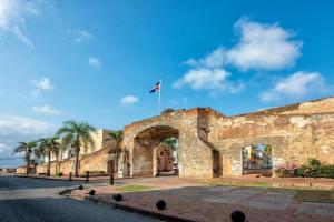 an old stone building with a flag on top of it at Comfort Home in La Cana