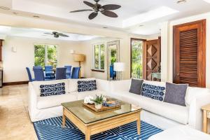 a living room with a white couch and a table at Villa La Percha in Providenciales