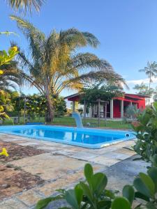 a swimming pool in front of a house at Pousada Canto Verde in Barreirinhas