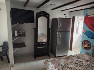 a room with a mirror and a refrigerator at El Hostal By Pochet in San Andrés