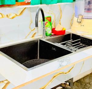 a black sink in a kitchen with a counter at Dew homestay in Wellawaya