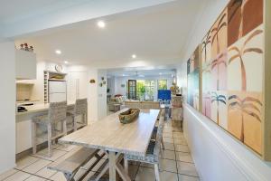 a kitchen and dining room with a table and chairs at Sandy Beach Resort in Noosaville