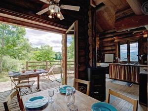 a dining room with a table and chairs in a cabin at Chalet chaud, nature sauvage, internet PC, idéal randonnées - FR-1-496-184 in Saint-Martin-la-Sauveté