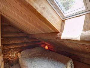 a bedroom in a log cabin with a window at Chalet chaud, nature sauvage, internet PC, idéal randonnées - FR-1-496-184 in Saint-Martin-la-Sauveté