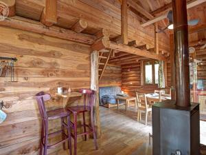 a log cabin living room with a wood stove at Chalet rustique avec poêle à bois - 3 pers, animaux admis - FR-1-496-187 in Saint-Martin-la-Sauveté