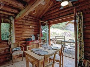 a dining room with a table and chairs in a cabin at Chalet rustique avec poêle à bois - 3 pers, animaux admis - FR-1-496-187 in Saint-Martin-la-Sauveté