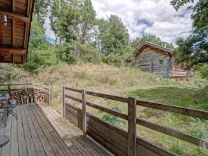 a wooden deck with a table and a cabin at Chalet rustique avec poêle à bois - 3 pers, animaux admis - FR-1-496-187 in Saint-Martin-la-Sauveté +9 photos