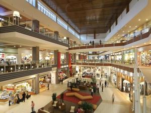 a large shopping mall with people walking in it at Rela More in Ginowan