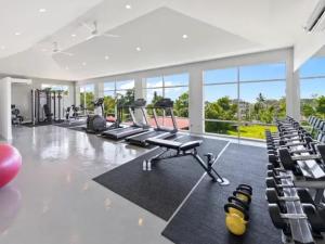 a gym with rows of exercise bikes and chairs at villaSAMU in Choeng Mon Beach