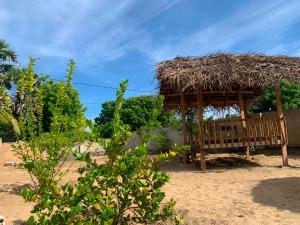 a hut with a bench on the beach at Thambili cabanas whisky point in Arugam Bay +21 photos