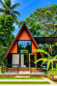 a small house with an orange roof at Lake Cabana in Udawalawe