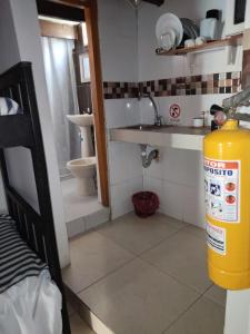 a small bathroom with a sink and a fire hydrant at El Hostal By Pochet in San Andrés +59 photos