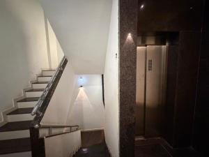 a staircase in a building with a light at the top at Gurukrupa Yatri Nivas in Kolhapur