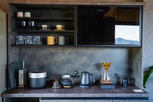 a kitchen counter with various appliances on it at Villa LUAR in Minamiawaji +7 photos