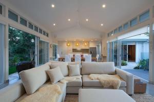 a living room with a white couch and a table at White Sands Beach House in Marcoola
