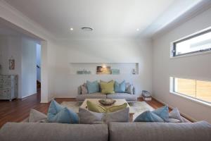 a living room with two couches and a couch at Green House in Marcoola +24 photos
