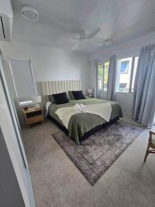 a bedroom with a large bed and a rug at Apartment on The Strand - 2 Bed 2 Bath in North Ward