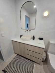 a bathroom with a sink and a mirror at Apartment on The Strand - 2 Bed 2 Bath in North Ward