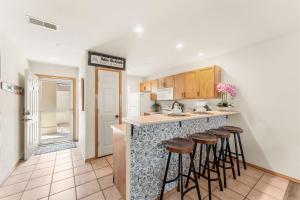 a kitchen with a counter with stools in it at Emerald Bay Escape with Sunroom in Hollister