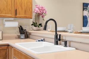 a kitchen counter with a sink in a kitchen at Emerald Bay Escape with Sunroom in Hollister +21 photos