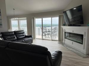 a living room with a couch and a fireplace at Spacious Lakeview Condo with 3 BR3 BA and Pool in Lake Ozark