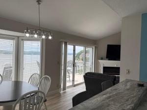 a dining room and living room with a table and chairs at Spacious Lakeview Condo with 3 BR3 BA and Pool in Lake Ozark