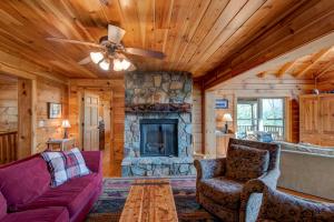 a living room with a couch and a fireplace at Chestnut Lodge in Boone