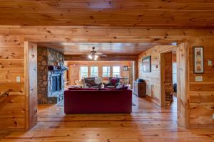 a living room in a log cabin with a couch at Chestnut Lodge in Boone