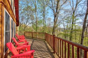 a row of red chairs sitting on a porch at Chestnut Lodge in Boone