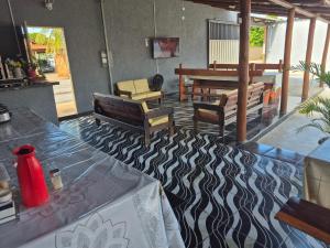 a room with chairs and a table with at Aconchego do Peruaçu in Itacarambi