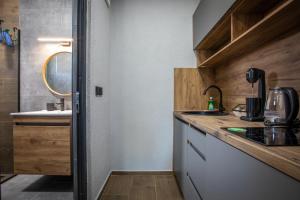a small kitchen with a counter and a sink at Sofia Luxury Apartments in Gevgelija