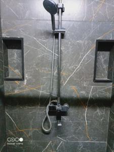 a shower head on a wall in a bathroom at Коттедж Бурабай улица Алатау 38 in Borovoye