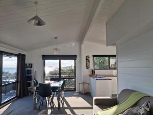 a living room with a table and a couch at Island view Experience in Coromandel Town