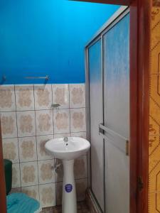 a bathroom with a white sink and a shower at CASA MARCELa in Altagracia +5 photos