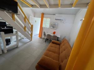a living room with a couch and a table at Sucriers in Garnier