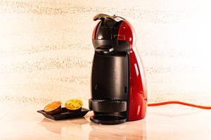 a red and black coffee maker sitting on a table at Hotel M in Oyodo