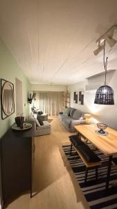 a living room with a couch and a table at Puerta Azul in Punta del Este +67 photos