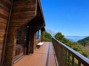 a balcony of a building with a bench on it at ヴィータ牛窓 in Setouchi