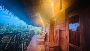 a porch of a wooden house with a balcony at Elegant Elephant Tree House Sigiiriya in Sigiriya