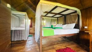 a bedroom with a canopy bed in a house at Elegant Elephant Tree House Sigiiriya in Sigiriya +27 photos