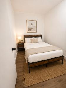 a bedroom with a large bed with a wooden frame at Santorini Shores in Biscayne Park