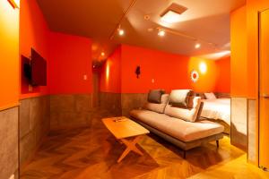 a living room with a couch and a bed at Hotel Beach-House in Otsu