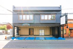 a house with a swimming pool in front of it at Hotel Beach-House in Otsu