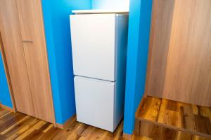 a white refrigerator in a room with blue walls at Hotel Beach-House in Otsu +115 photos