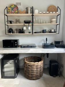 a kitchen counter with a sink and a microwave at Market on 5 in Piet Retief