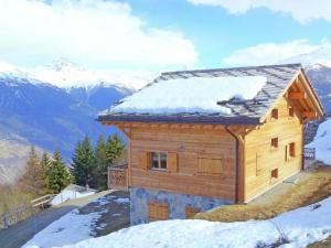 a wooden house on top of a snowy mountain at Modern Chalet with bubble bath in Les Collons in Les Collons