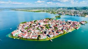 an island in the middle of a body of water at Maple Guest House in Flores