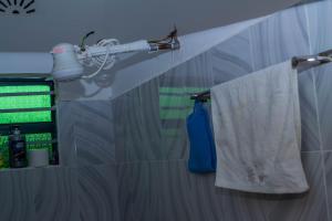 a bathroom with a sink and a shower curtain at M's BNB in Bungoma